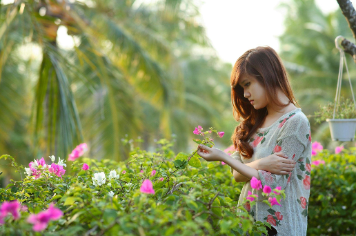 Girl in thought while holding flowers